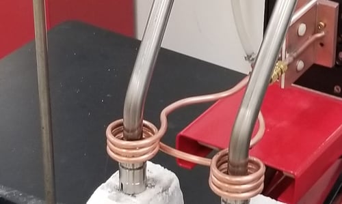 Induction brazing both ends of a steel assembly