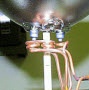 Braze a mount lead to a ferrule in a PAR light bulb assembly for automobiles