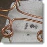 image: Heating four brass inserts for a plastic motor housing